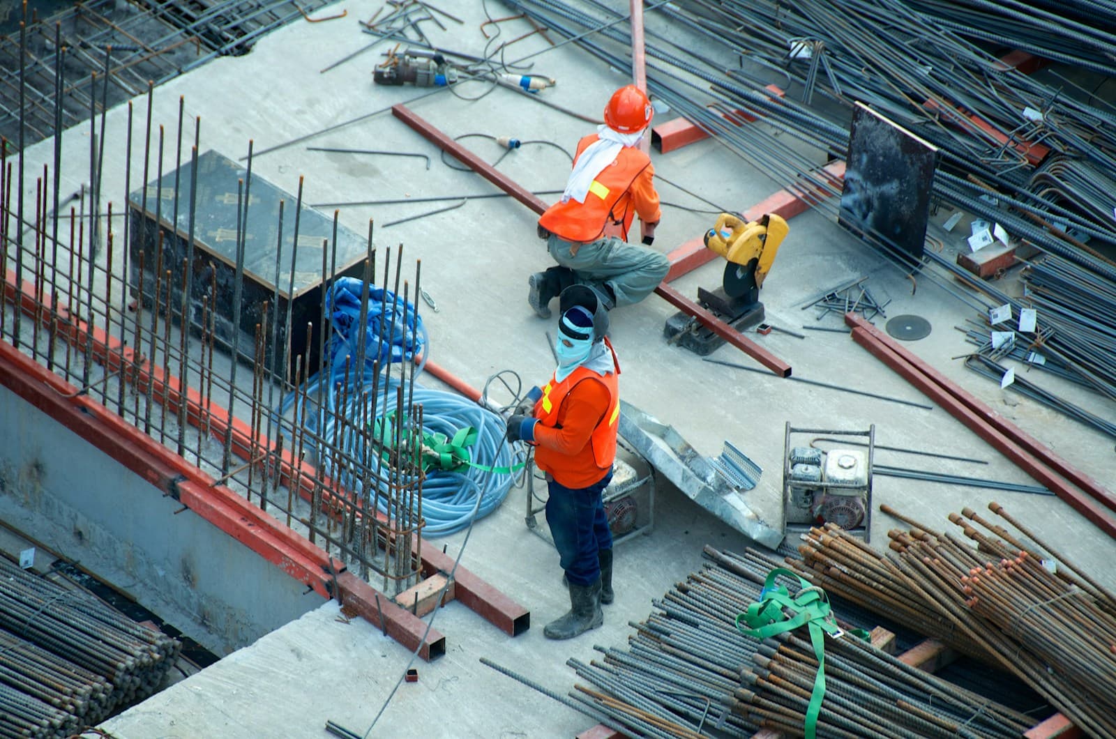 Overhead view of workers placing steel rebar and conduit before a concrete pour
